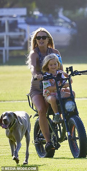 Elyse seemed to be having a great day in the sun, smiling as she rode happily through the park, her hair blowing in the breeze.