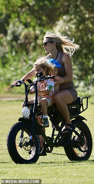 Elyse seemed to be having a great day in the sun, smiling as she rode happily through the park, her hair blowing in the breeze.