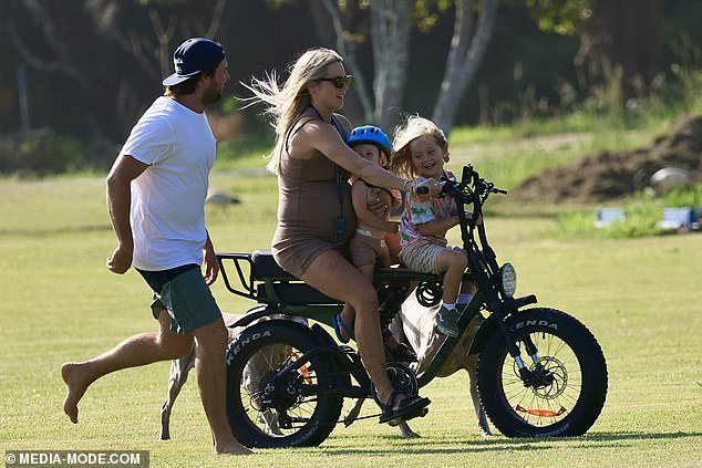 The adventurous model even managed to balance both children on the bike at one point.