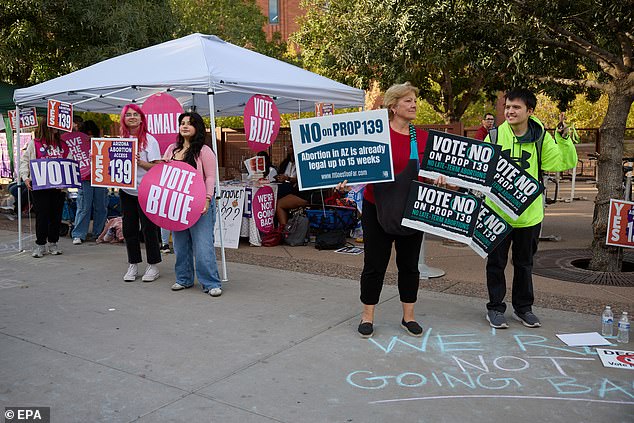 Supporters for and against Proposition 139, for abortion access, try to get students to vote on Election Day at Arizona State University in Tempe, Arizona.