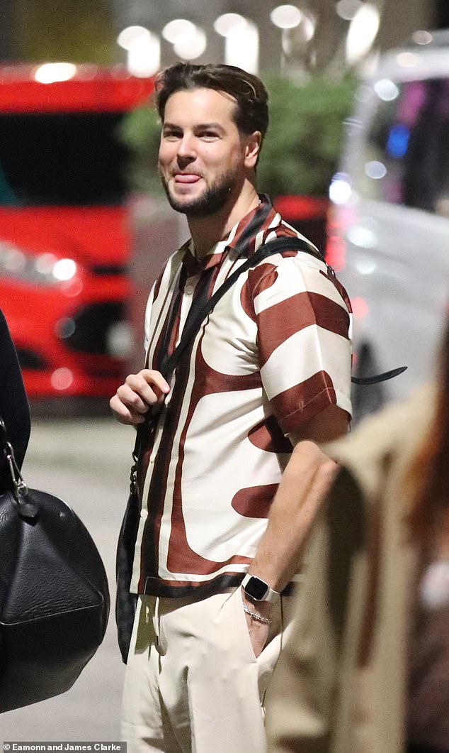 Love Island star Chris Hughes braved the cold in a silky printed short sleeve shirt