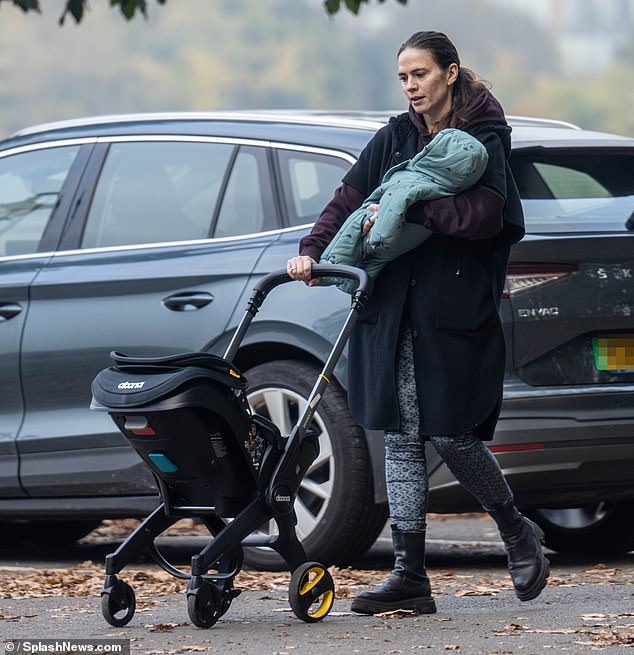 The Marvel star also kept warm in an oversized fleece jacket and maroon hoodie, which she wore with extravagant leggings and chunky boots.