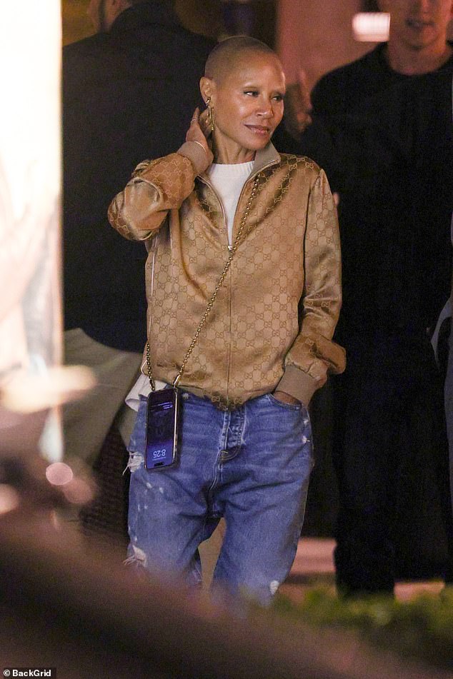 Jada looked casually cool in a gold jacket and jeans while chatting with her husband, who was wearing a gray jacket, white t-shirt and pants.