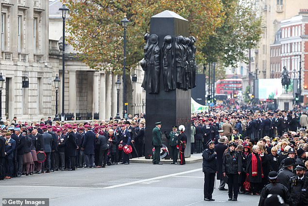 People have gathered near the Women of the Second World War Memorial in London.