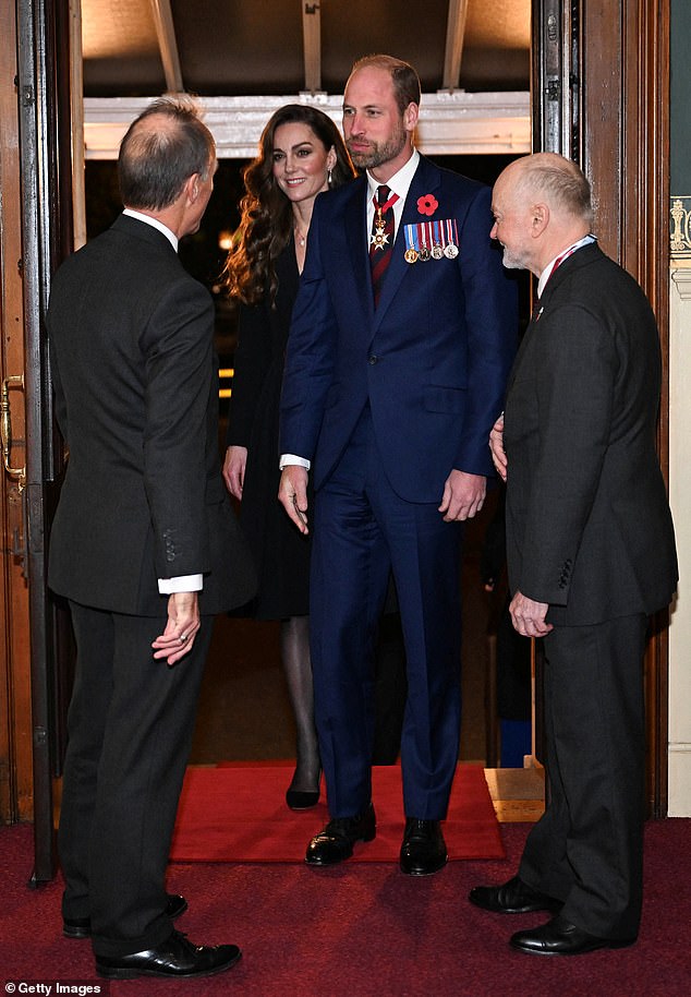 A bearded Prince William optimistically enters the Royal Albert Hall in a blue suit alongside Princess Kate