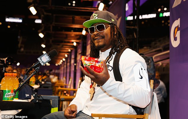 Running back Marshawn Lynch addresses the media before Super Bowl XLIX in January 2015