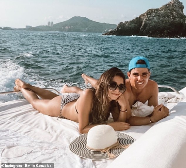 González poses while on vacation with his long-time girlfriend Fernanda (left)