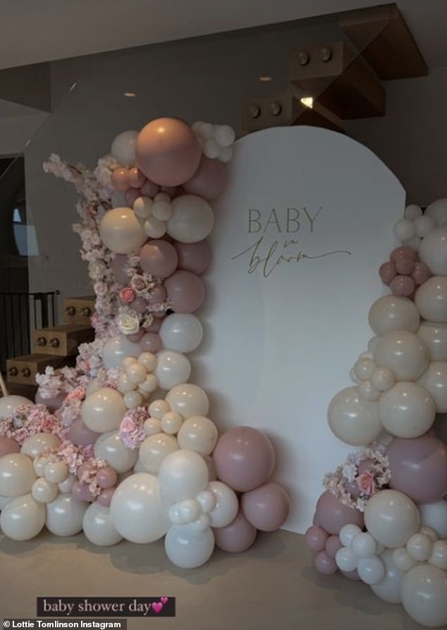 Lottie decorated her home with a pretty floral and balloon arch in the center in front of her staircase.