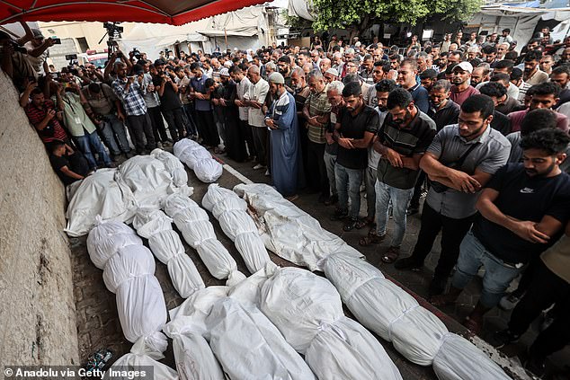 Relatives of Palestinians who lost their lives in Israeli attacks in Az-Zawayda district perform a funeral prayer