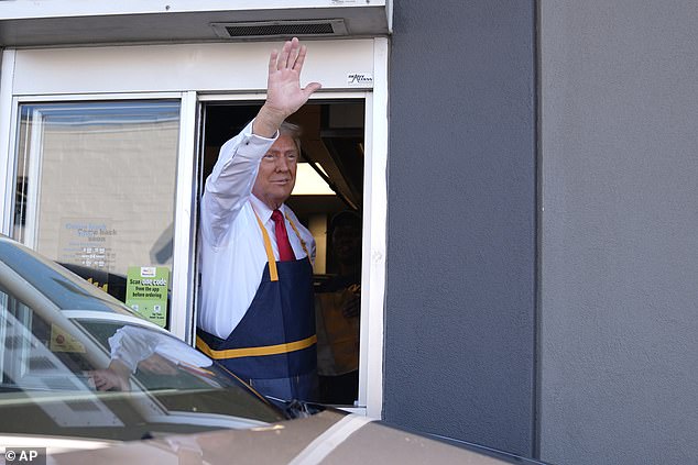 Trump waved to the crowd through the serving window during his shift at the restaurant.