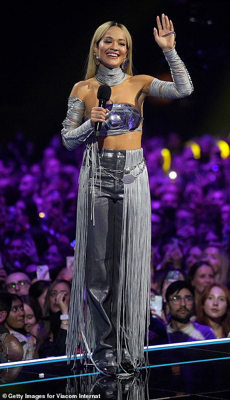 Another wardrobe change saw her adopt a futuristic look with a silver metal bustier and fringed jeans.