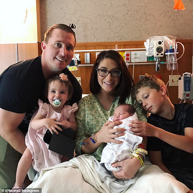 They share two daughters, Sailor, eight, and Atlee, seven. (Pictured: An undated image of the family in a hospital room after Atlee's birth)