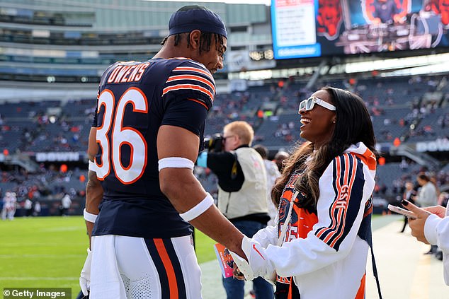 The couple was all smiles as they joked together on the sideline at Chicago's Soldier Field.