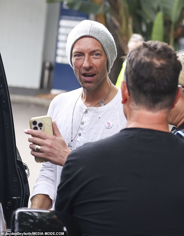 The Coldplay frontman was all smiles as he spoke to fans at an impromptu meet-and-greet after his arrival.