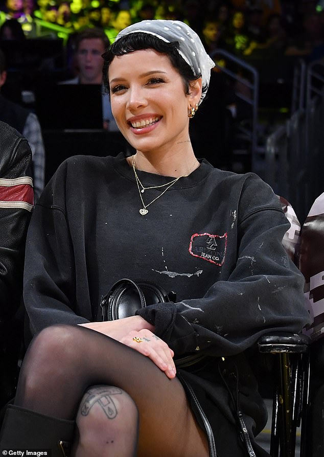 She looked radiant in a worn sweatshirt and shorts paired with knee-high boots as she enjoyed her evening at Crypto.com Arena.