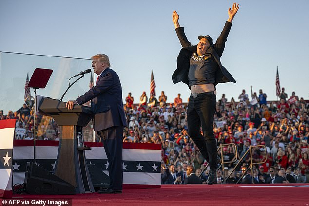 Musk jumps on stage as he joins Trump during a campaign rally at the site of his first assassination attempt in Butler, Pennsylvania, on October 5, 2024.