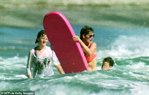 Princess tries to catch a wave on her bright pink board in Nevis