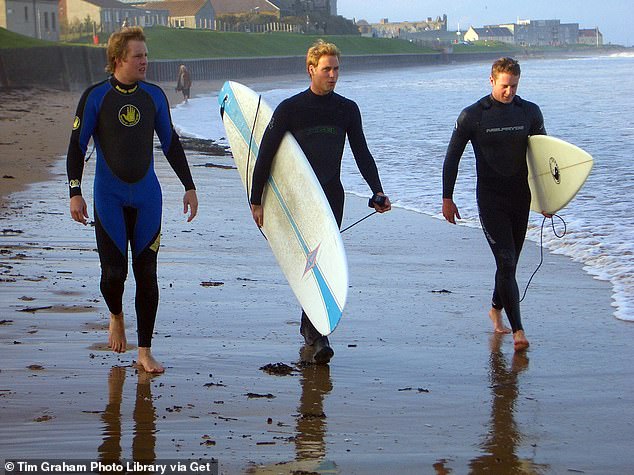 Prince William, 22, walking along St Andrews beach with two friends in 2004.