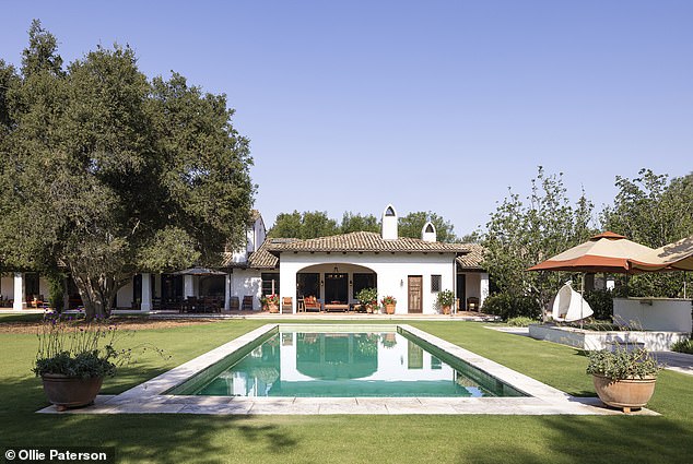 The exterior of the house and guest house were painted Santa Barbara white, with a mix of tile and wood floors inside and wood beams lining the ceiling.