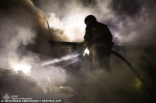 A rescuer works at the site of a Russian overnight attack in Mykolaiv, Ukraine, early Monday morning.