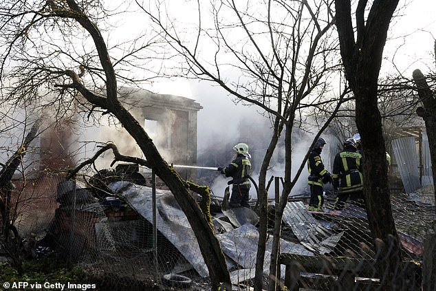 Rescuers work to extinguish a house fire following a drone attack in the village of Stanovoye, Moscow Region, on November 10.