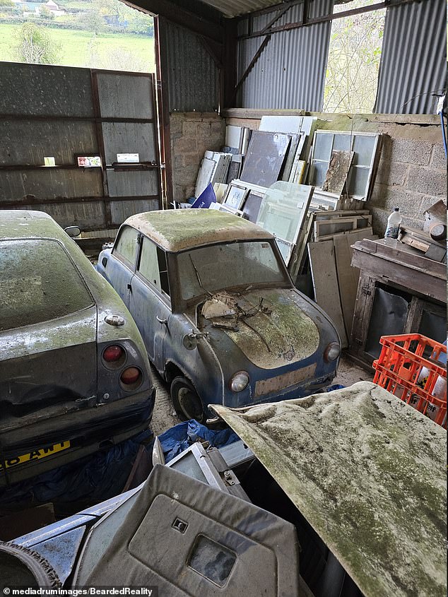 A microcar next to a Fiat Coupé, both rotting among the hidden collection located somewhere in Wales.