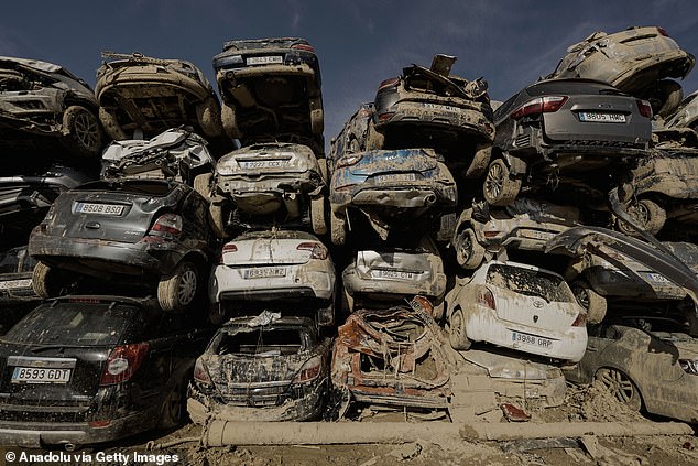 The snapshots, taken at a scrapyard on the outskirts of the Valencian town of Paiporta, show rows and rows of cars still covered in mud stacked on top of each other.