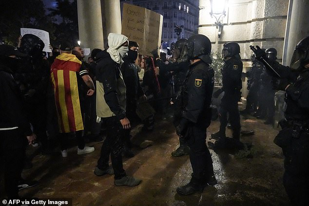 Protesters confront police in front of the town hall during a demonstration to demand the resignation of Valencia regional president Carlos Mazón in Valencia on November 9, 2024.