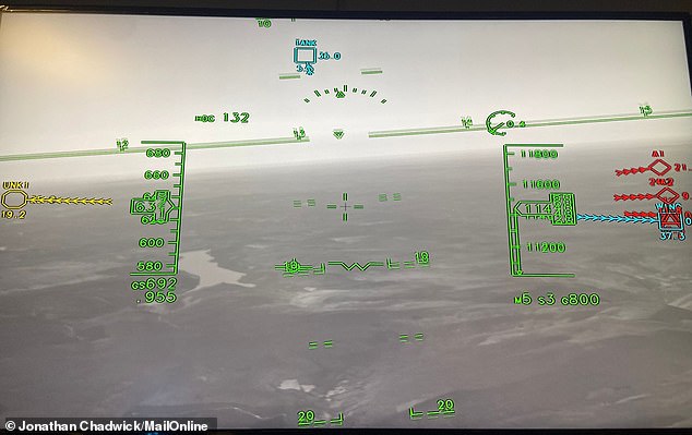 The photo shows the view with the helmet on, with speed shown on the left and altitude on the right. Notice the colored shapes, which indicate objects in the air and on the ground.