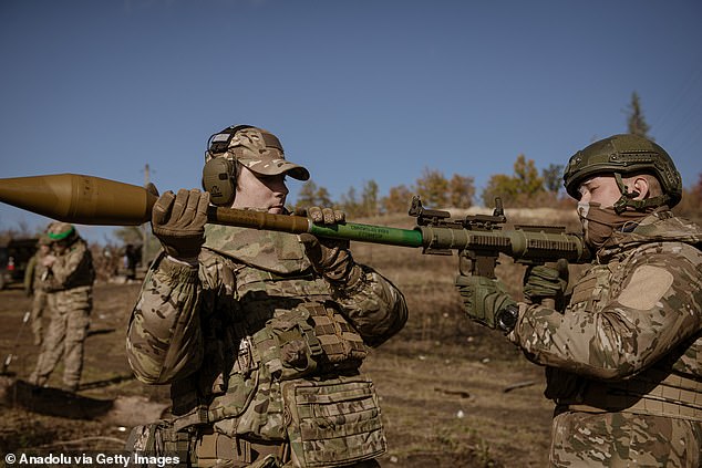 Soldiers and commander learn how to use an RPG launcher during a training of the drone unit of the 24th Brigade of the Armed Forces of Ukraine on shooting with various weapons, medical evacuations and deployment of tactical medicine in the region from Donetsk, Ukraine, on October 26, 2024.