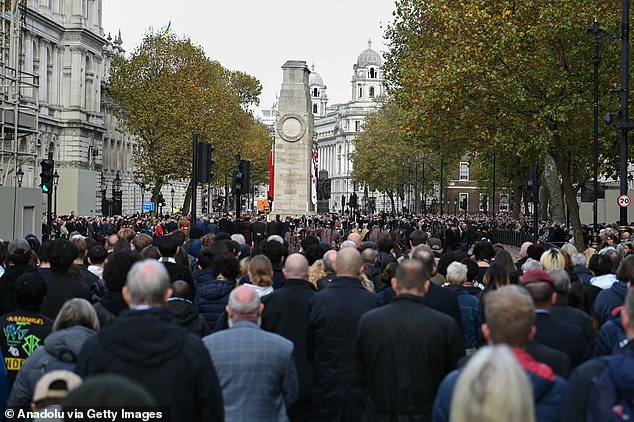 People are seen standing in silence during a Remembrance Day service in Whitehall, London