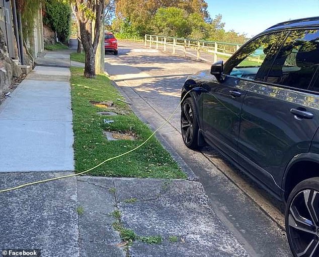 Mosman Council on Sydney's north shore required electric vehicle owners to stop running electric cables on public footpaths as it poses a risk to pedestrians (pictured, a Volvo XC90 recharging in the luxury Mosman).