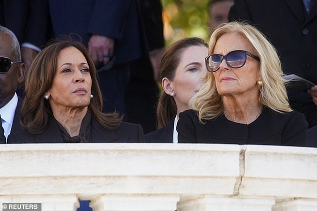 A stoic-looking Vice President Kamala Harris (left) sat next to first lady Dr. Jill Biden (right) awaiting President Joe Biden's remarks at the Veterans Day ceremony at Arlington National Cemetery on Monday.