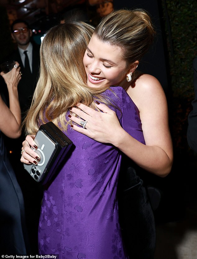 The sisters - who have 17 years between them - hugged each other at the party at the Pacific Design Center in Los Angeles.