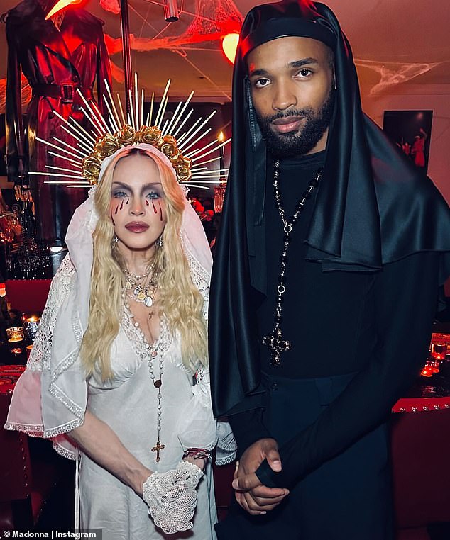 On Halloween, Madonna wore a floor-length white dress with a plunging neckline and a white lace veil, and said she was dressed as 