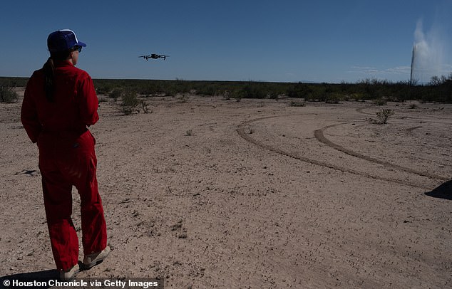 Sarah Stogner uses a drone to obtain images and video of a produced water geyser in West Texas as it emerges from the ground in Toyah.