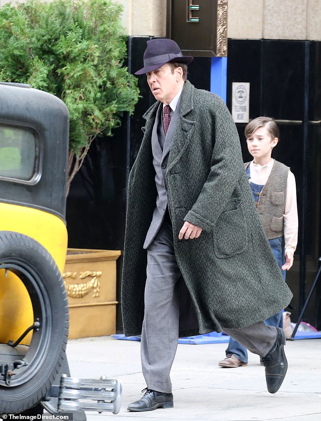 On Monday, he was seen filming next to several vintage cars as he channeled his role as a private investigator in the 1930s.