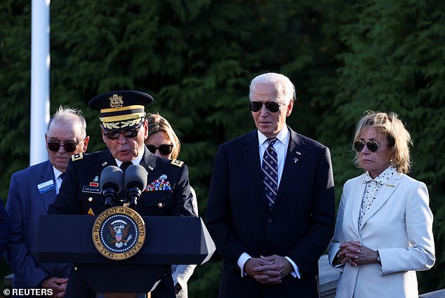 President Joe Biden (center right) with his sister Valerie Biden (right) at a plague dedication for the late Beau Biden marking Veterans Day on Monday.