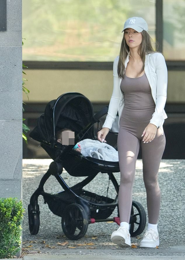 His rarely seen girlfriend, Karlie Butler, wore brown sportswear while taking a solo stroll with their son Mercy, whom the couple welcomed in January.