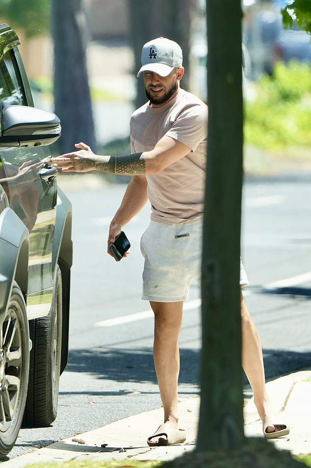 Meanwhile, the billionaire businessman appeared to be out running some errands while wearing a nude T-shirt and white shorts.