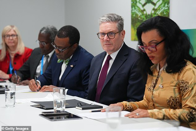 Keir Starmer, pictured holding a financial roundtable, insisted Britain can show the way on climate change as he attended the COP29 summit today.