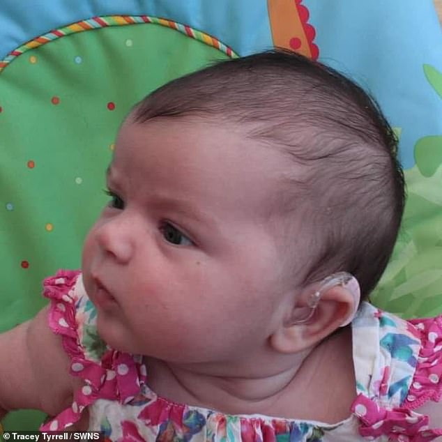 Audrey Tyrrell at six weeks with her first pair of pink hearing aids