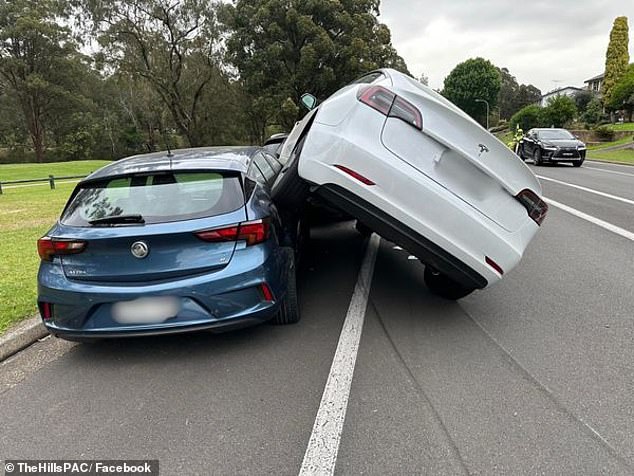 The force of the crash rammed the Holden into a third car - a black Mercedes (pictured)