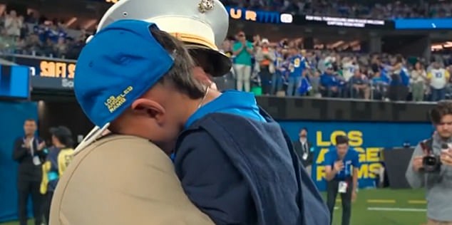 Justin held up his son Leo, a Rams fan, as they both cried in the 'biggest roar of the night.'