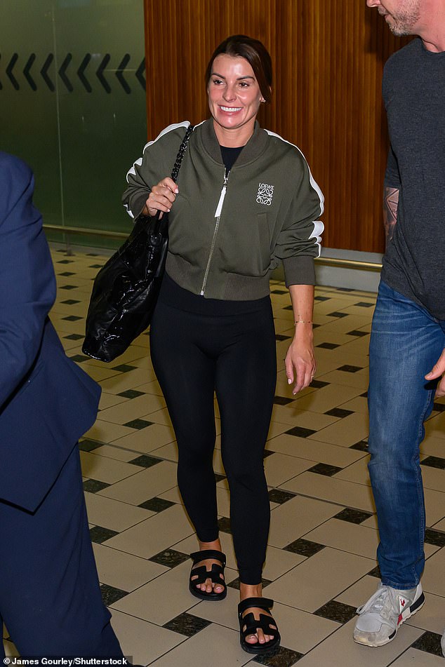 Coleen Rooney arrives at Brisbane Airport in Australia, carrying a Chanel leather handbag worth £1,762, a £1,000 nylon bomber jacket from Loewe, with black leggings and Hermes gladiator sandals, worth £730.