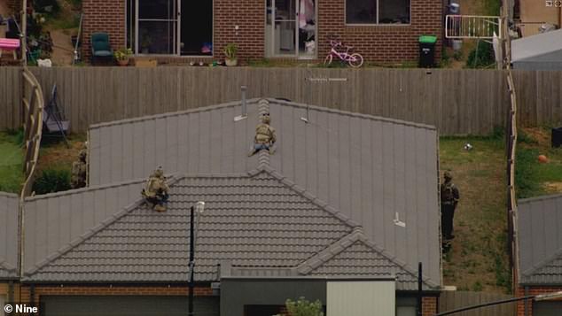 SOG snipers prepare to eliminate the gunman on a nearby rooftop.