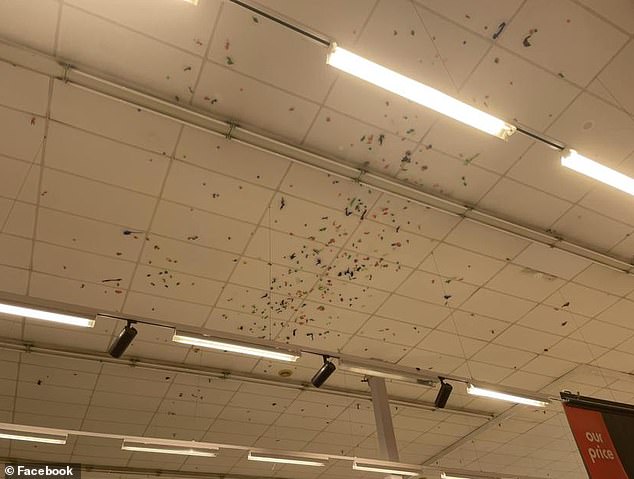 Hundreds of sticky toys are stuck to the ceiling above the children's section of Kmart