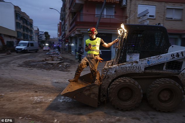 A firefighter helps clean up the flood-affected municipality of Paiporta, Valencia province, Spain, November 12, 2024