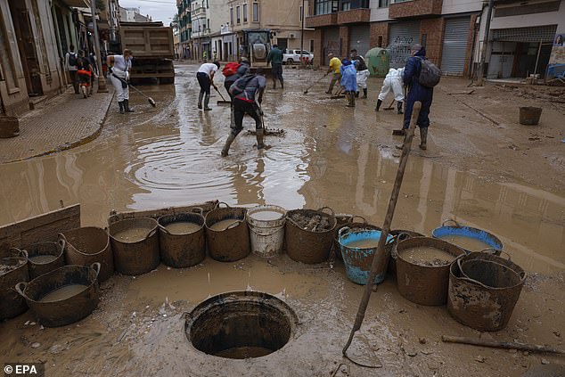 Volunteers help clean up the flood-affected municipality of Paiporta, Valencia province, Spain, November 12, 2024