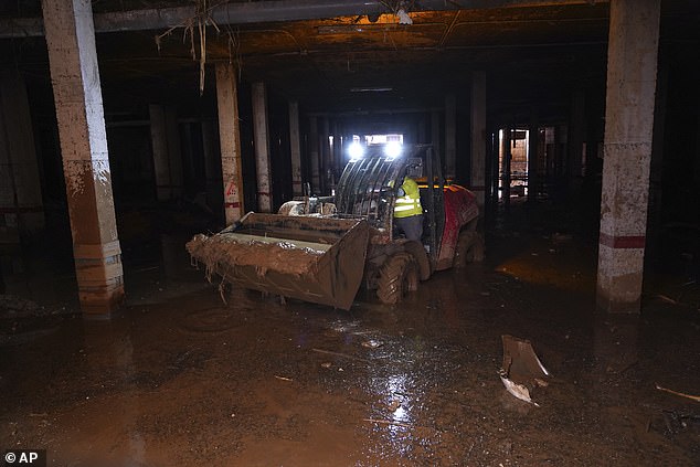 Mud is collected after flooding in Catarroja that left hundreds dead or missing in the Valencia region of Spain, Tuesday, November 12, 2024.